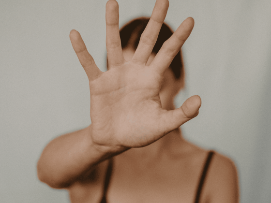 white woman's hand up to the screen palm facing out, covering her face, illustration Have you considered adoption if this doesn’t workt fertility now article