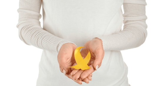 endometriosis self care woman holding a yellow ribbon