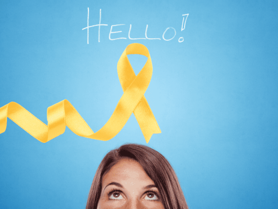 blue background woman looking up from centere bottom at the yellow endo awareness ribbon and the word hello!