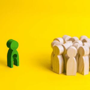 wooden pg dolls, one green to the left, has a child size hole missing from it, illustrating the hurt of words for infertility