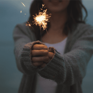 woman holding a lit sparkler, illustrationg the fire of endo