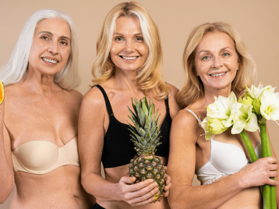 Geriatric and pregnancy three older women holding fertility symbols, a ppaya, a pineapple and a calli lilly