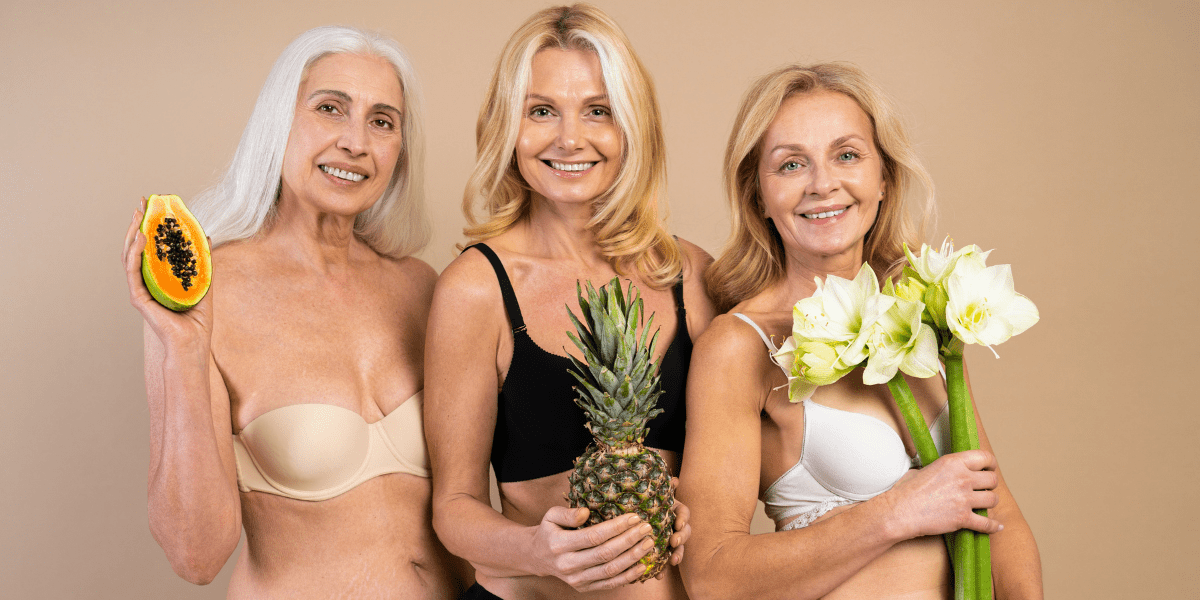 Geriatric and pregnancy three older women holding fertility symbols, a ppaya, a pineapple and a calli lilly